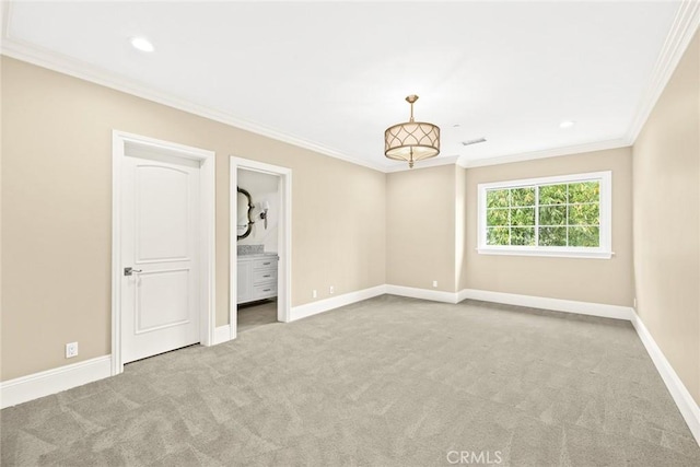 unfurnished bedroom featuring ensuite bathroom, crown molding, and light carpet