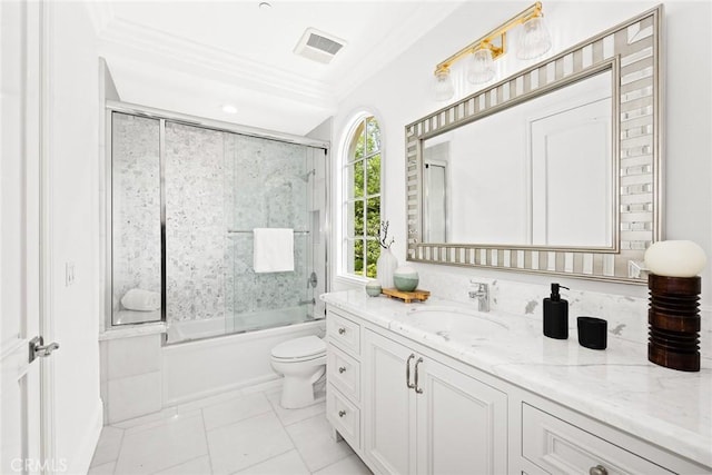 full bathroom featuring vanity, tile patterned floors, crown molding, bath / shower combo with glass door, and toilet