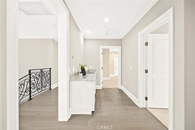 hall featuring light hardwood / wood-style floors and crown molding