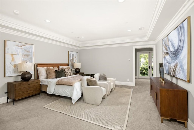 carpeted bedroom with crown molding and a tray ceiling