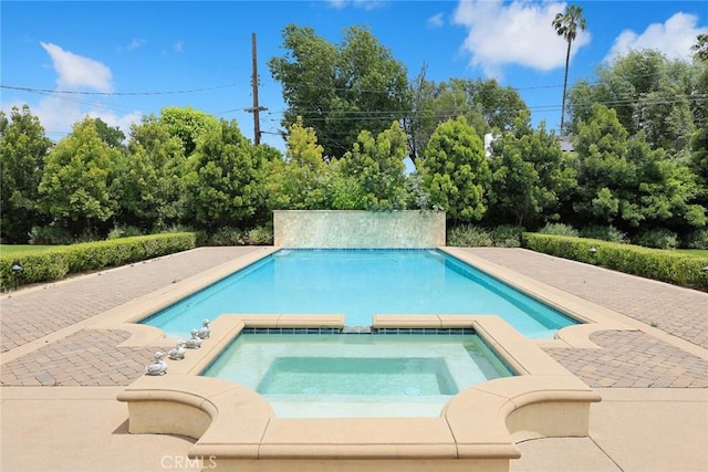 view of swimming pool featuring an in ground hot tub and a patio