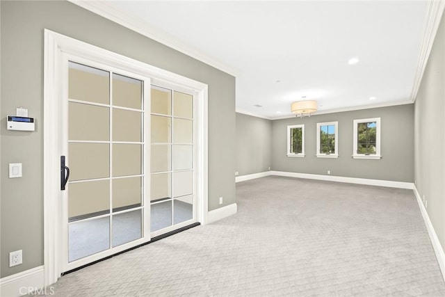 carpeted spare room featuring crown molding