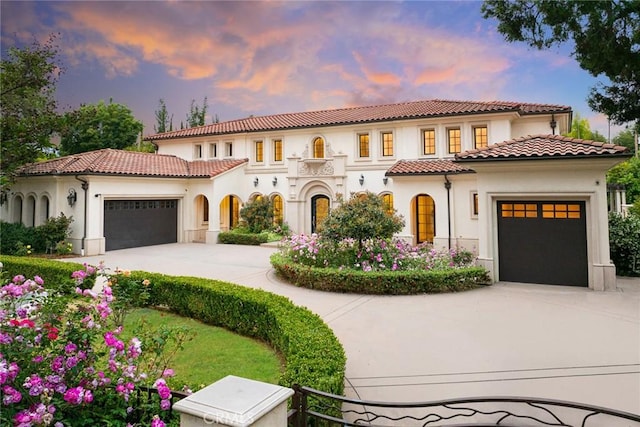 mediterranean / spanish house featuring a garage