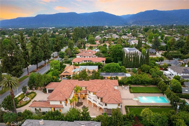 aerial view at dusk featuring a mountain view