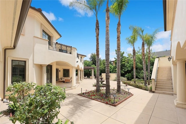 view of patio featuring a balcony