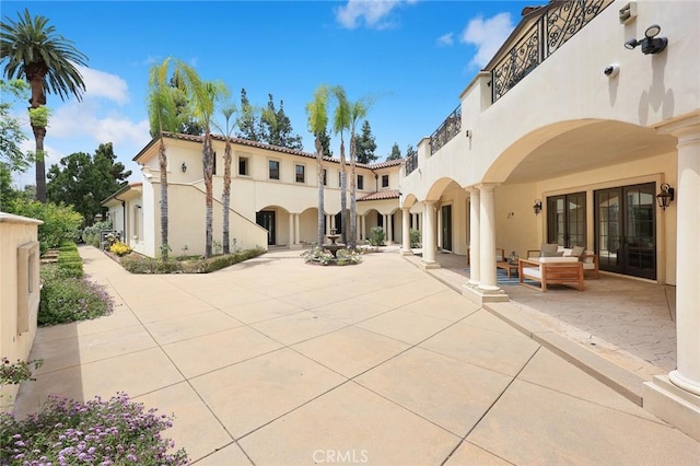 rear view of house with french doors and a patio area