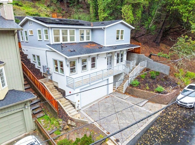 back of house featuring solar panels