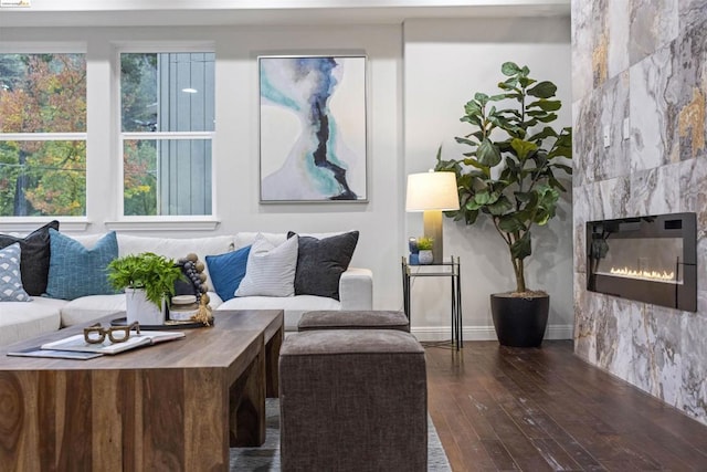 living room with dark hardwood / wood-style flooring and a tile fireplace