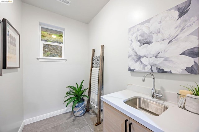 bathroom with tile patterned flooring and vanity