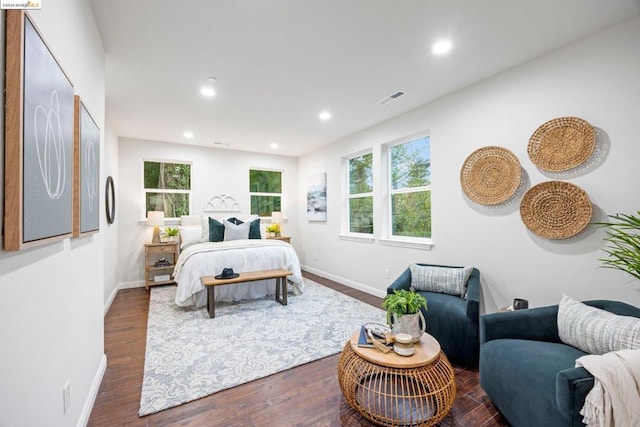 bedroom with dark wood-type flooring and multiple windows