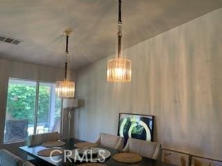 dining area featuring breakfast area and a notable chandelier