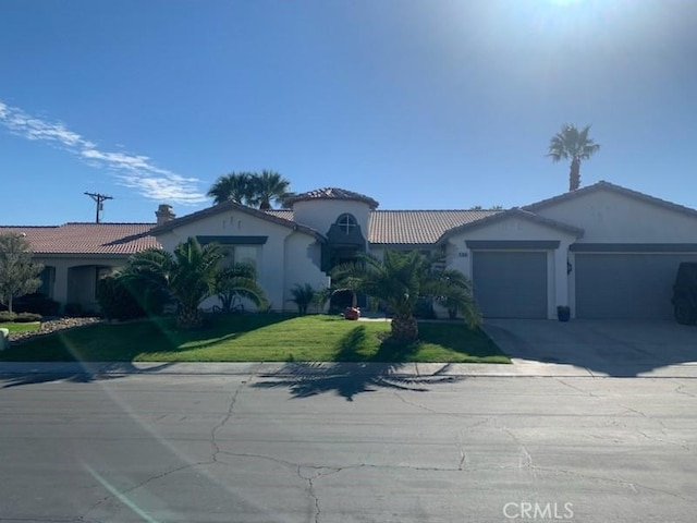 view of front facade featuring a front yard and a garage