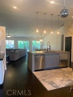 kitchen featuring decorative light fixtures, ceiling fan, stainless steel dishwasher, sink, and white cabinets