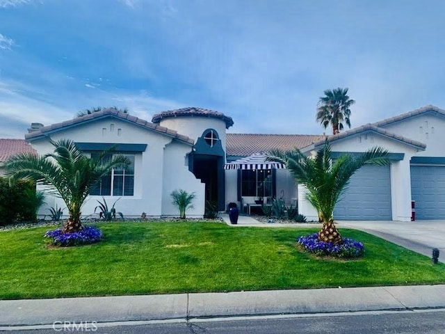 mediterranean / spanish-style home with a front yard and a garage