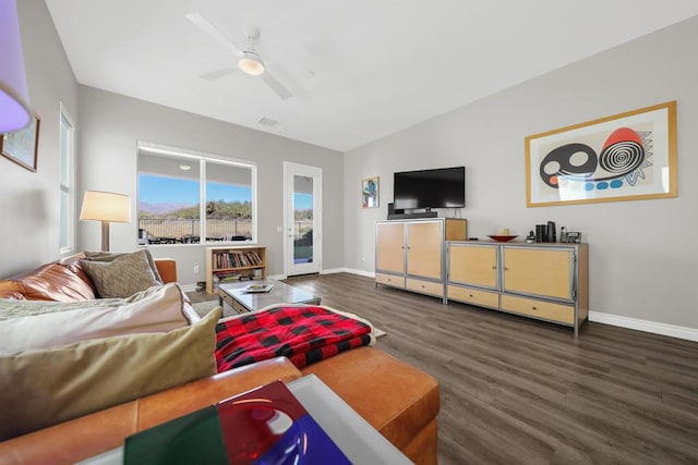 living room with ceiling fan, lofted ceiling, and dark wood-type flooring