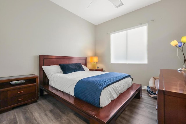 bedroom featuring dark hardwood / wood-style flooring and vaulted ceiling