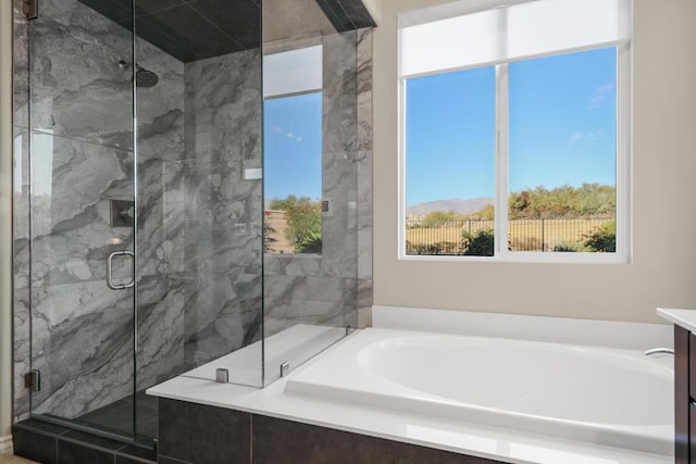 bathroom featuring shower with separate bathtub and vanity