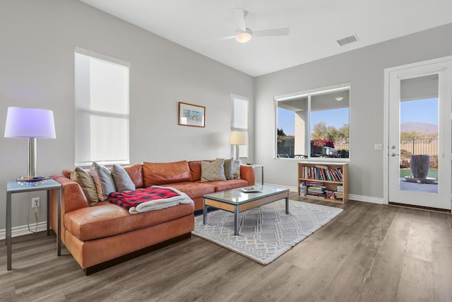 living room featuring ceiling fan, plenty of natural light, and hardwood / wood-style floors