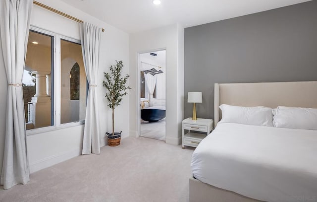 bedroom featuring light carpet, a closet, and a walk in closet