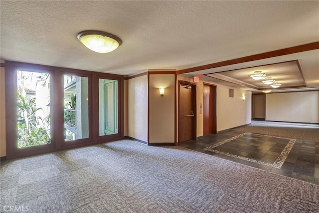 unfurnished room featuring dark carpet and a textured ceiling