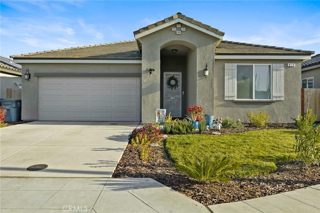 view of front of property featuring a garage and a front lawn