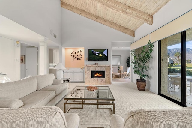 living room featuring wooden ceiling, light carpet, high vaulted ceiling, a premium fireplace, and beamed ceiling