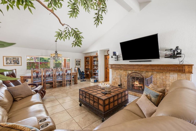 living room with beam ceiling, a tile fireplace, high vaulted ceiling, a chandelier, and light tile patterned flooring