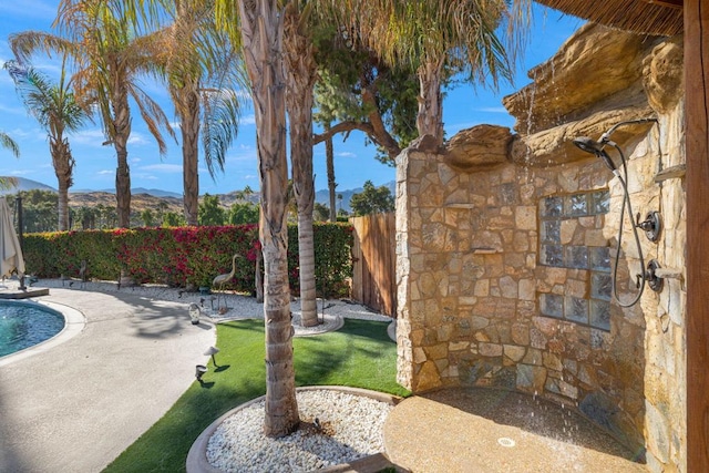 view of swimming pool featuring a mountain view and a patio area