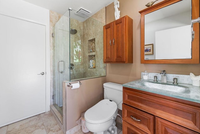 bathroom featuring tile patterned flooring, vanity, toilet, and walk in shower