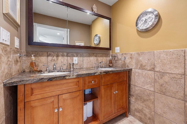 bathroom featuring vanity and tile walls