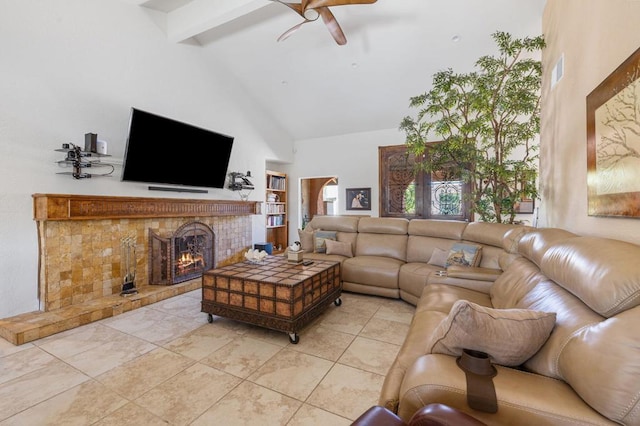 tiled living room with ceiling fan, beam ceiling, a fireplace, and high vaulted ceiling