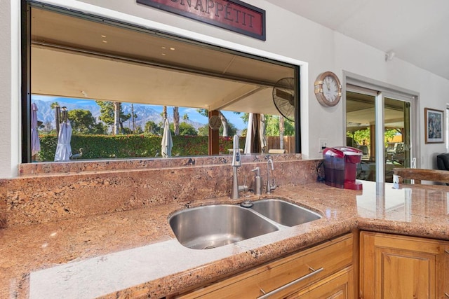 kitchen with light stone countertops and sink