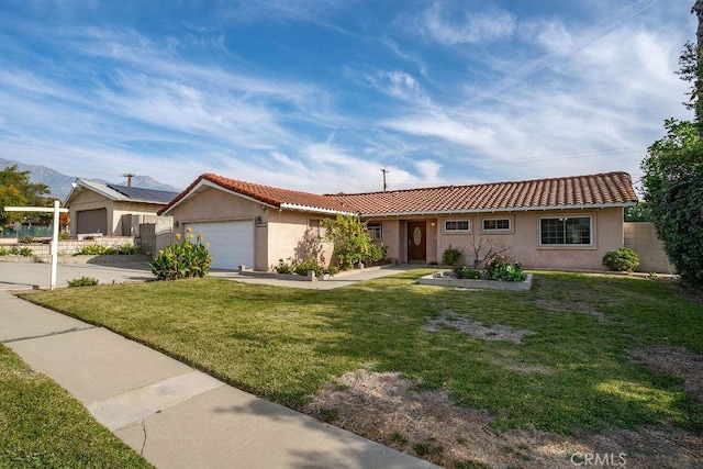 single story home with a front yard and a garage