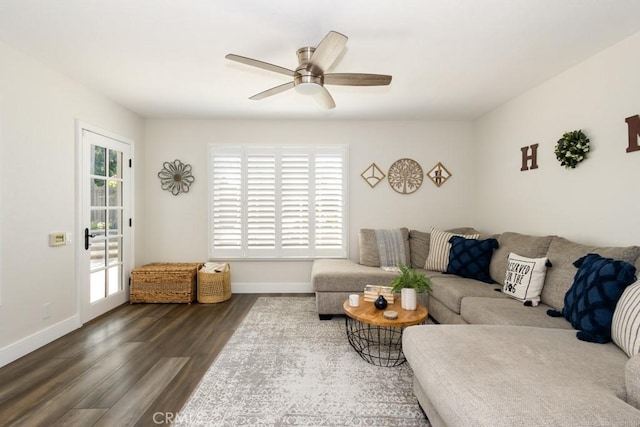 living room featuring ceiling fan and dark hardwood / wood-style flooring