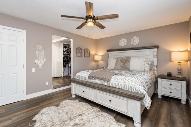 bedroom with dark hardwood / wood-style floors, ceiling fan, a spacious closet, and a closet