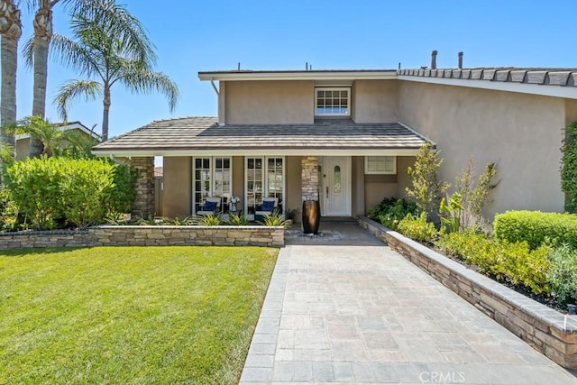 view of front of house with covered porch and a front yard