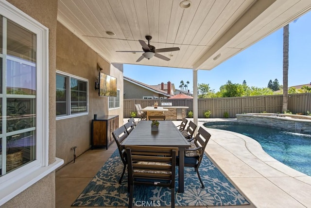 view of swimming pool featuring pool water feature, ceiling fan, area for grilling, and a patio area