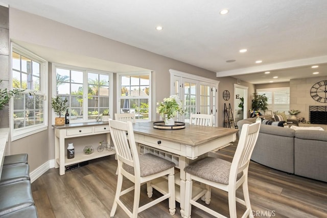 dining room with a fireplace and dark hardwood / wood-style floors