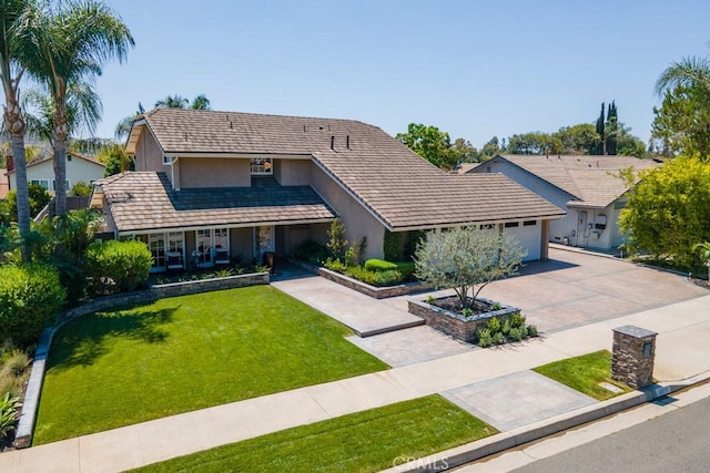 view of front of property featuring a front lawn and a garage