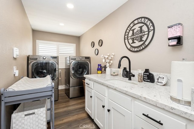 laundry area featuring dark hardwood / wood-style flooring, separate washer and dryer, and sink