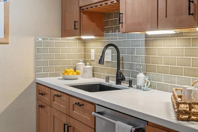 kitchen with dishwasher, decorative backsplash, and sink