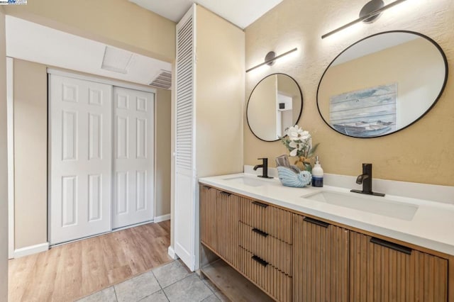 bathroom with vanity and wood-type flooring