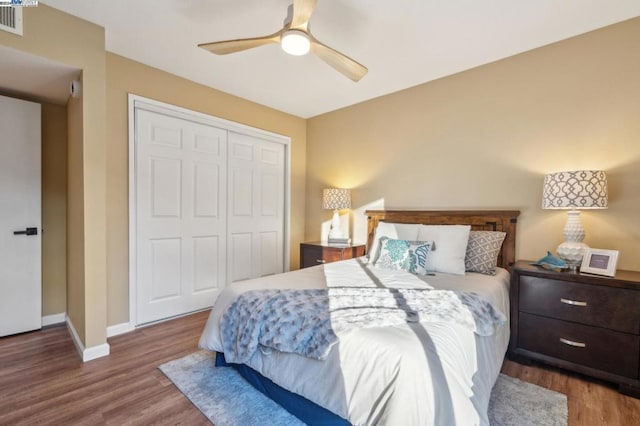 bedroom featuring hardwood / wood-style floors, a closet, and ceiling fan