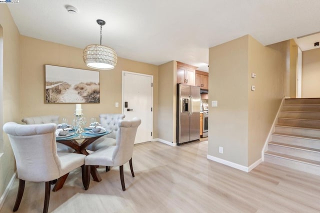 dining space with light wood-type flooring