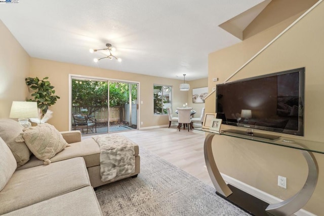 living room with a chandelier and light hardwood / wood-style floors