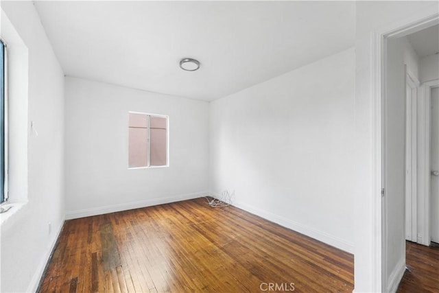 spare room with dark hardwood / wood-style floors