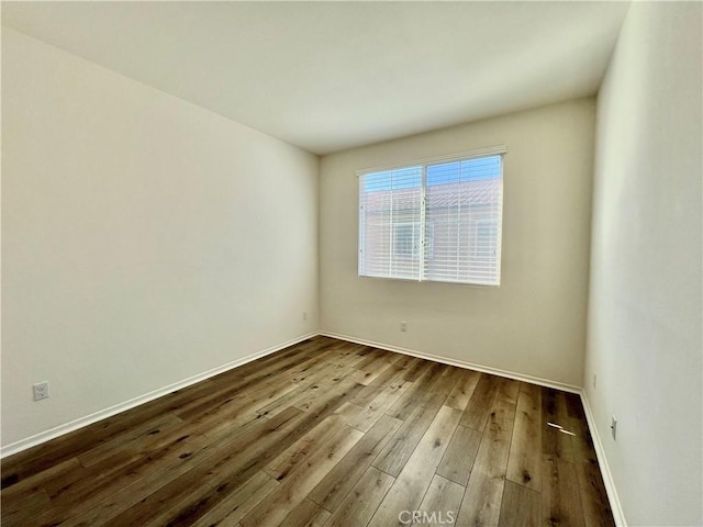 spare room featuring wood-type flooring