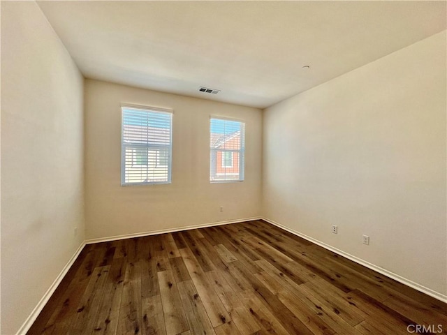 unfurnished room featuring dark hardwood / wood-style flooring