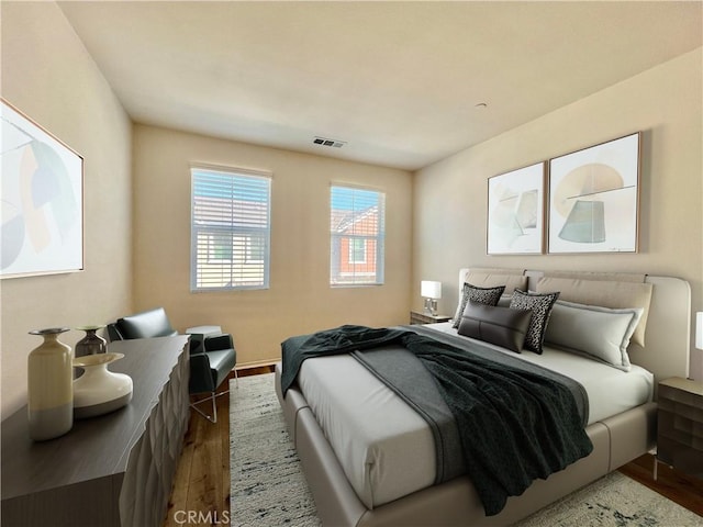 bedroom with dark wood-type flooring