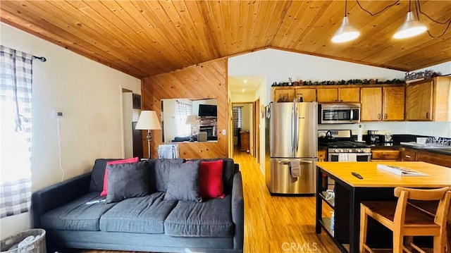 kitchen featuring pendant lighting, lofted ceiling, wooden ceiling, appliances with stainless steel finishes, and light hardwood / wood-style floors